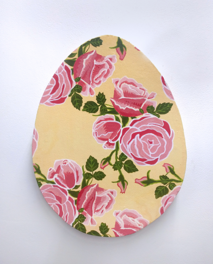 an egg shaped canvas with a painted pink rose pattern