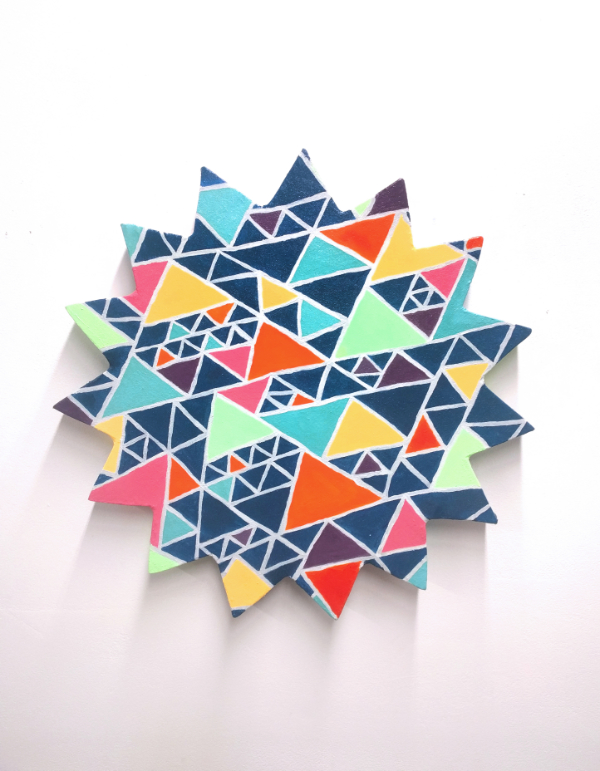 a star shaped canvas with a multicolored triangle pattern